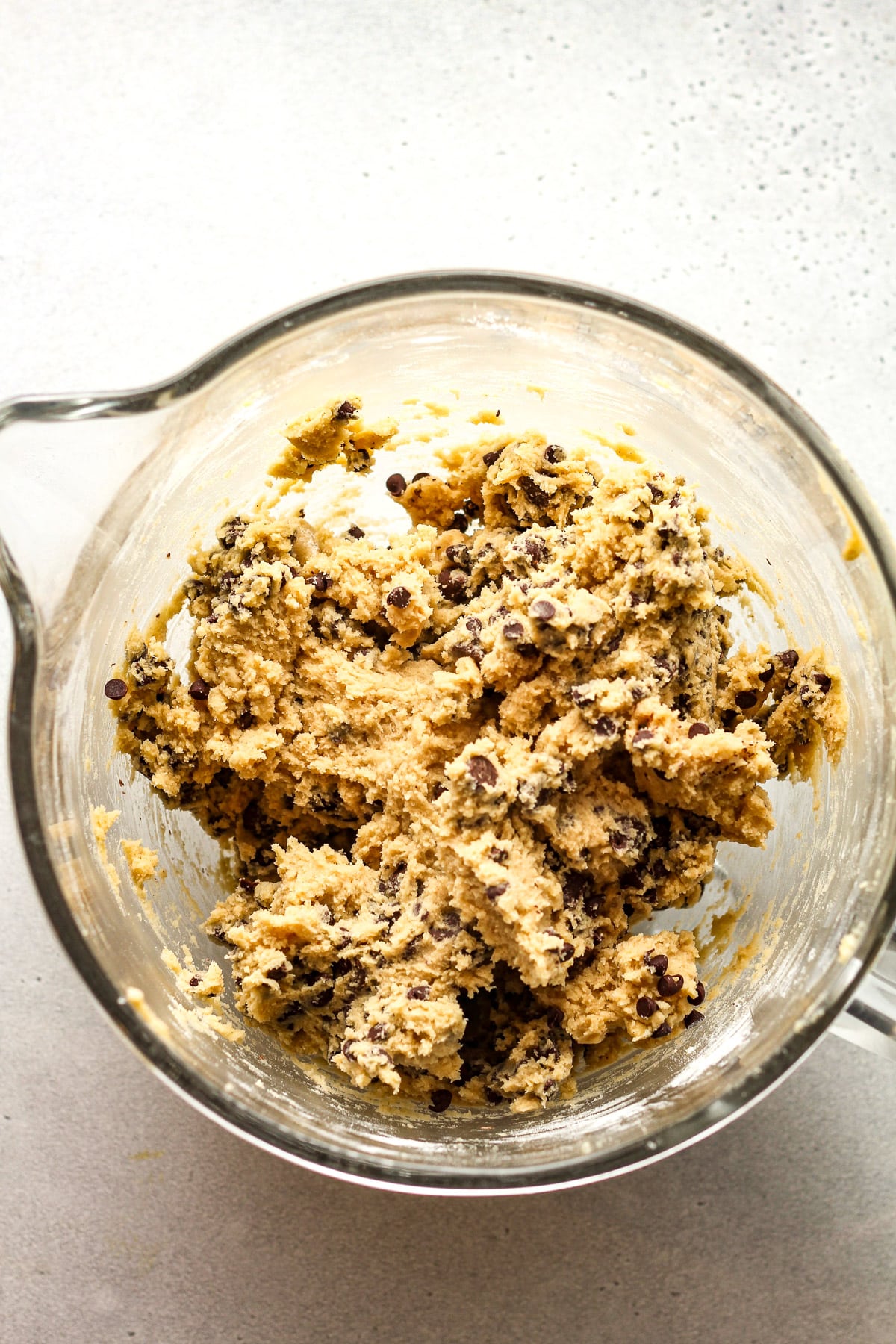 A mixer bowl of the chocolate chip cookie dough.