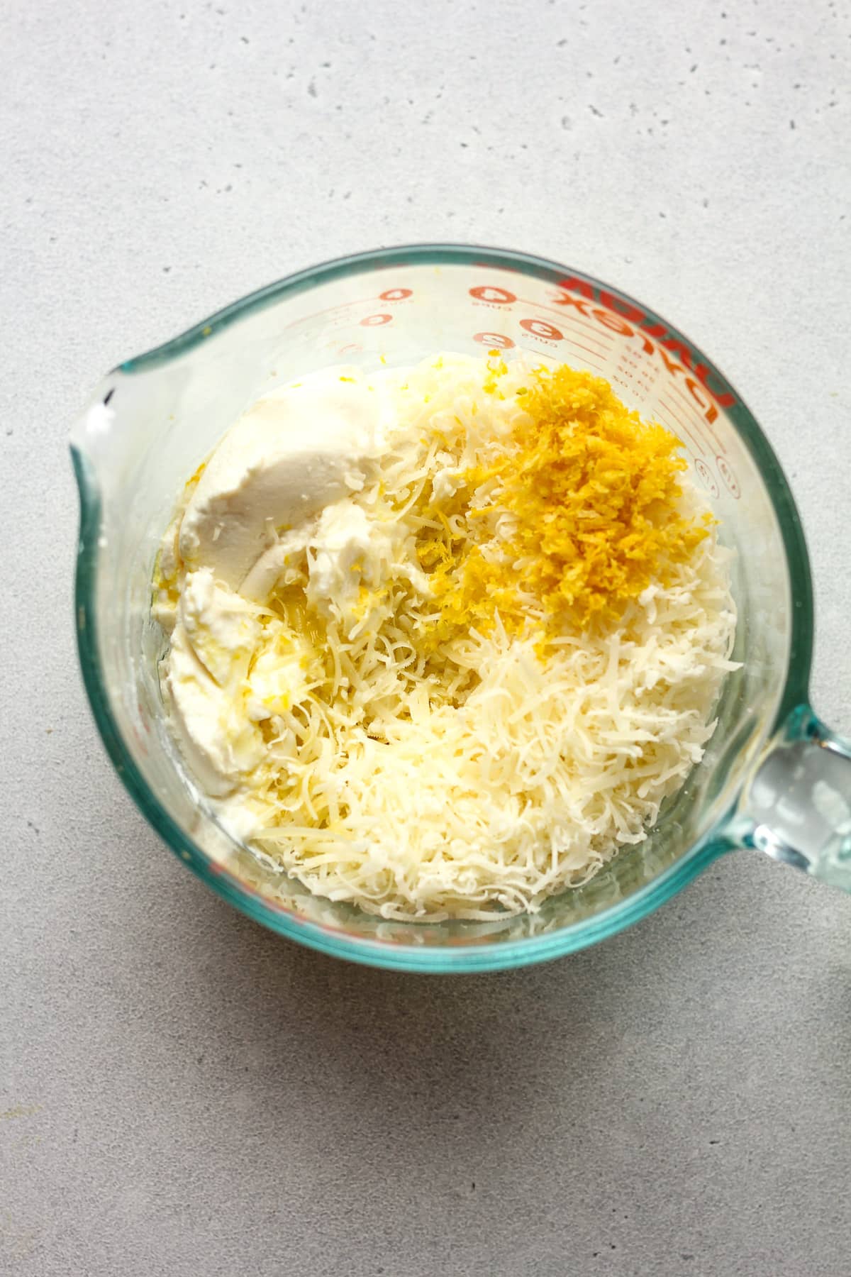 A large measuring cup of the ricotta sauce ingredients.