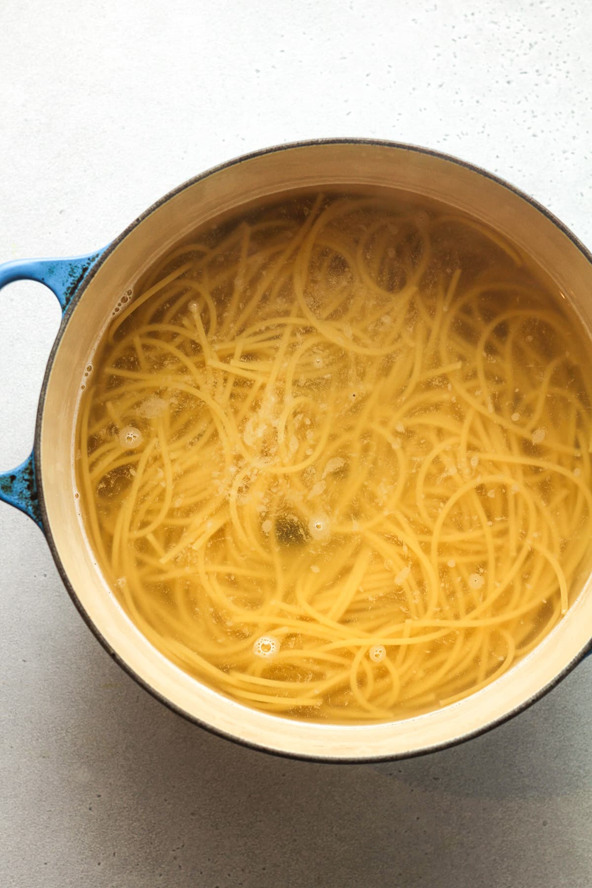 A pot of the cooked spaghetti noodles.