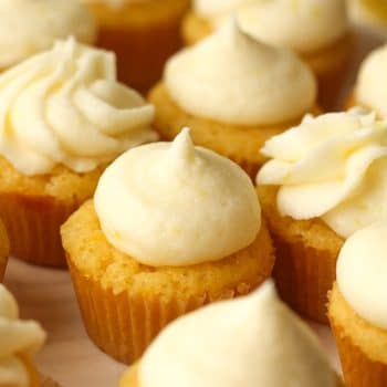 Closeup on a plate of mini lemon cupcakes.