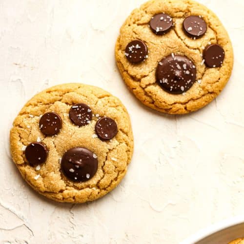 Overhead view of two paw prints cookies sprinkled with salt.