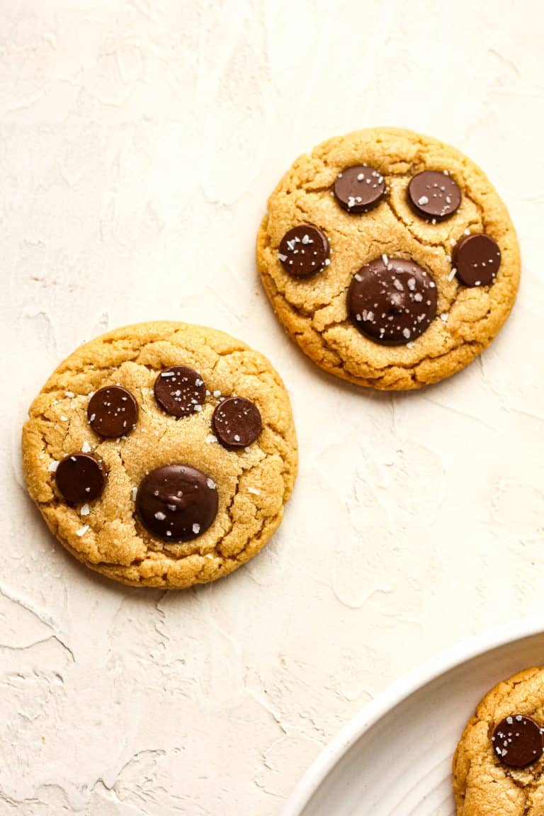 Overhead view of two paw prints cookies sprinkled with salt.