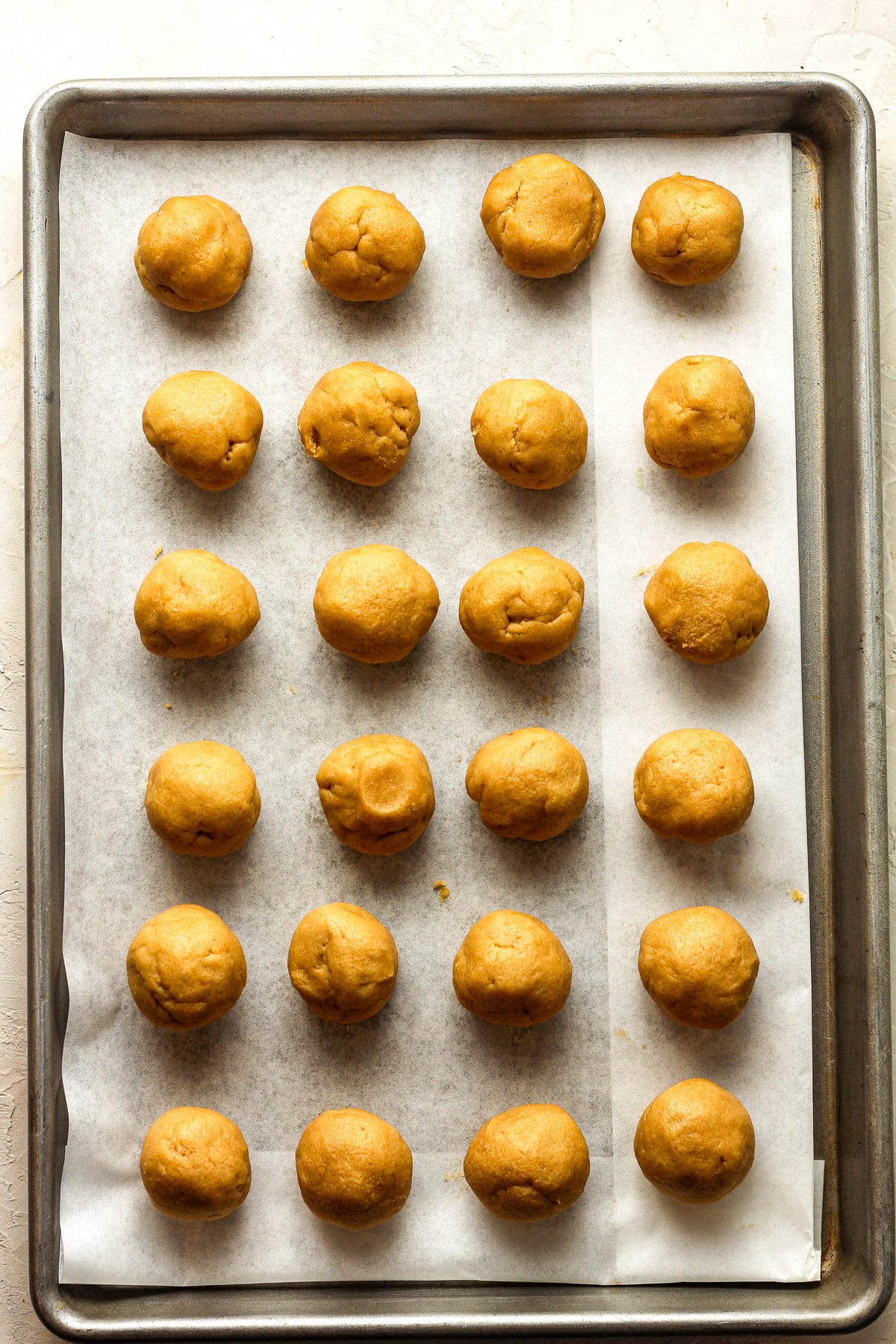 A pan of rolled peanut butter cookie balls.