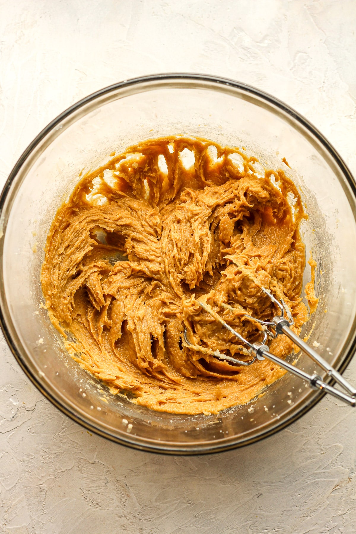 A bowl of the mixed wet ingredients for the paw print cookies.