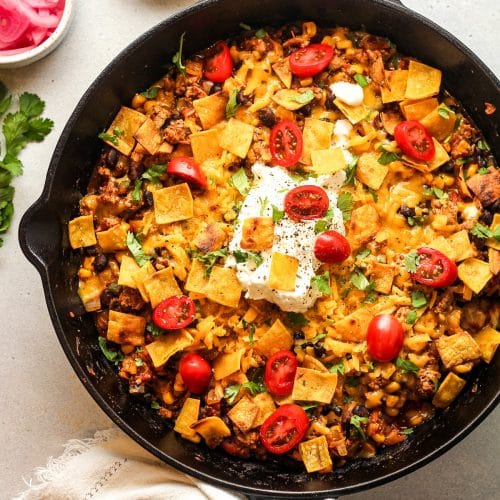 Overhead view of a large skillet with ground turkey taco mixture plus toppings.