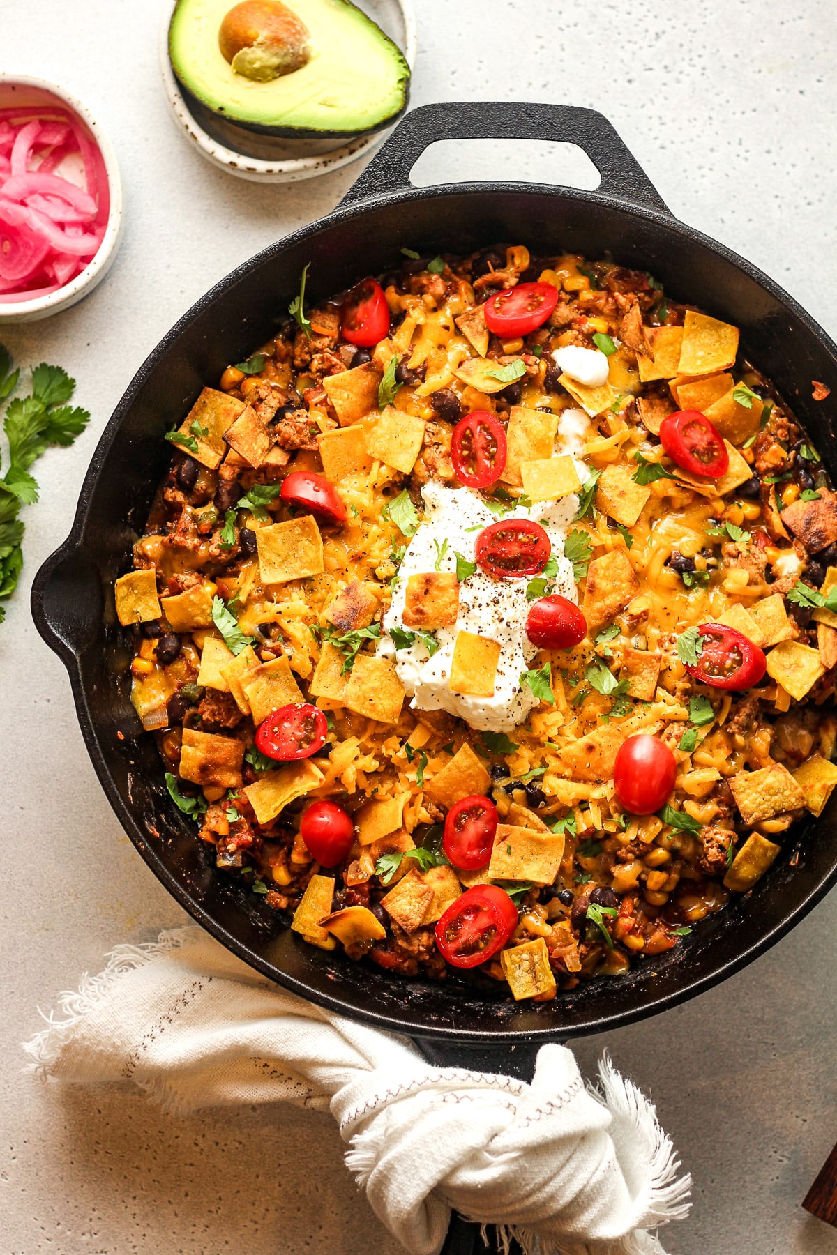 Overhead view of a large skillet with ground turkey taco mixture plus toppings.