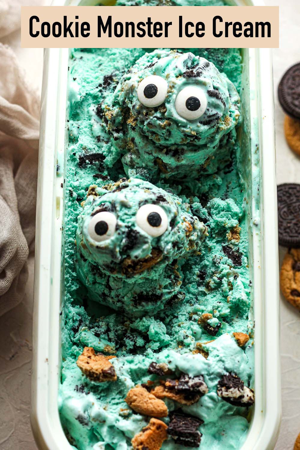 Closeup view of two scoops of Cookie Monster ice cream in a white container.