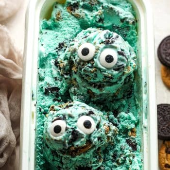 Overhead view of two scoops of Cookie Monster ice cream in an ice cream container with eyeballs.