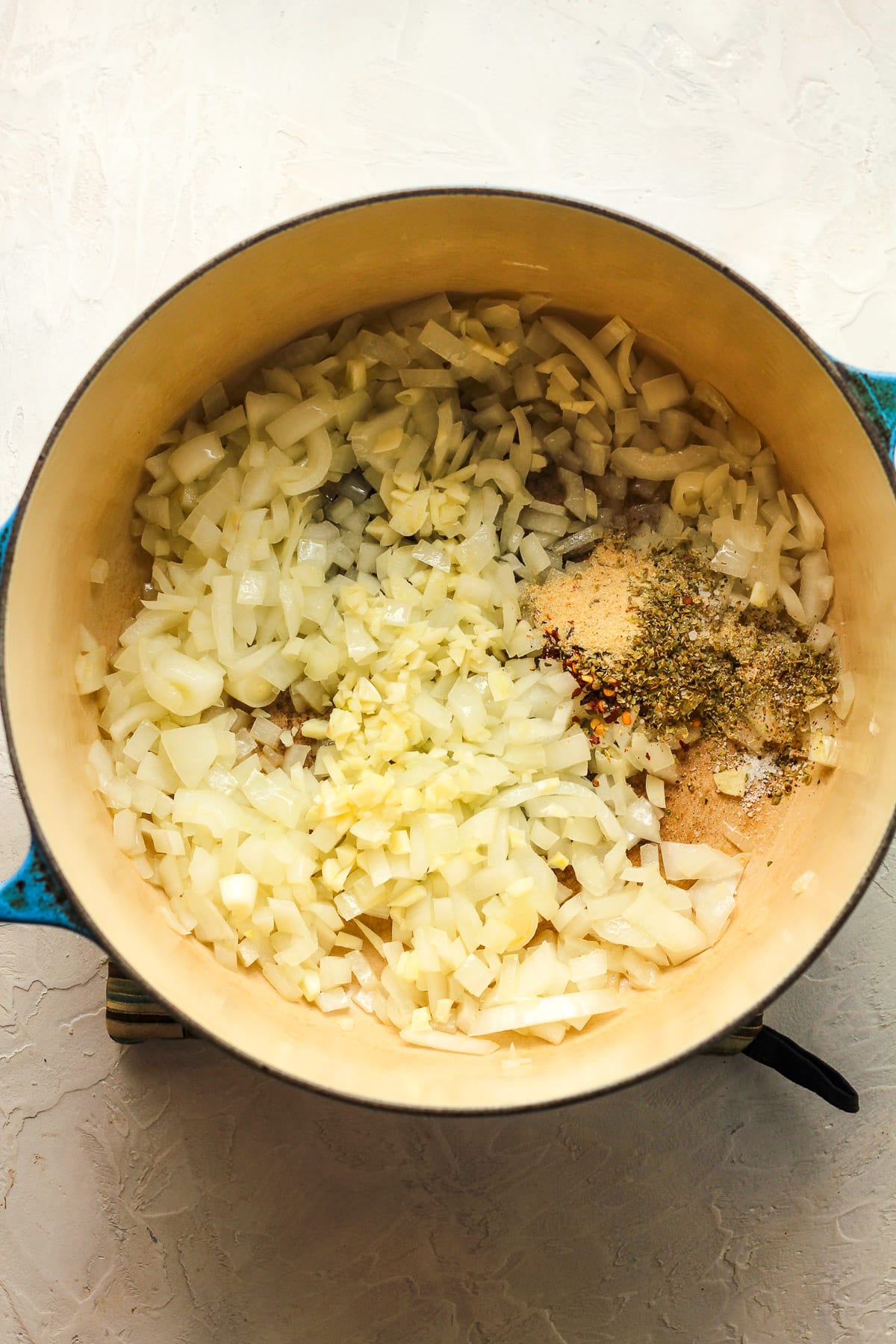 A stock pot of the sautéed onions and the garlic and seasonings.