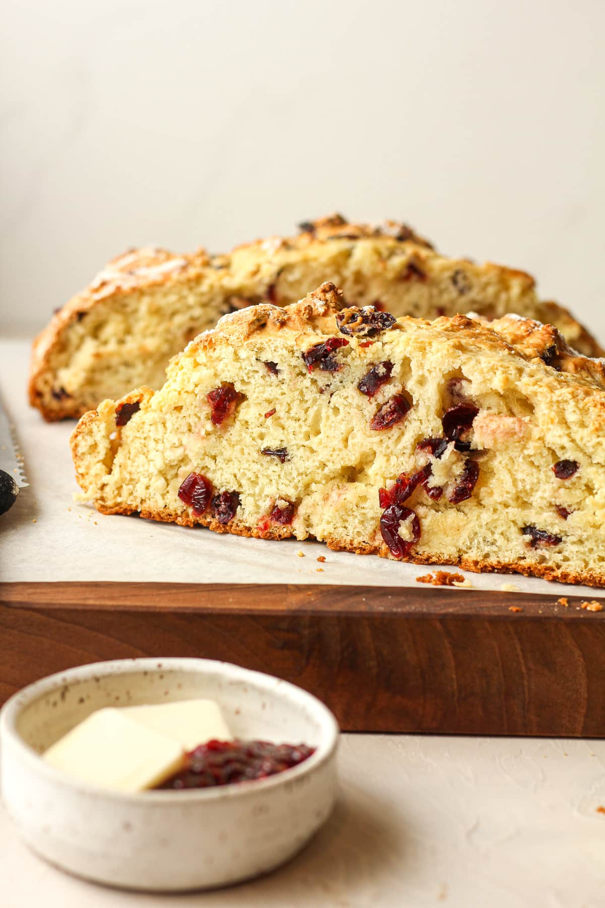 Side view of a halved loaf of Irish soda bread showing the insides with cranberries.