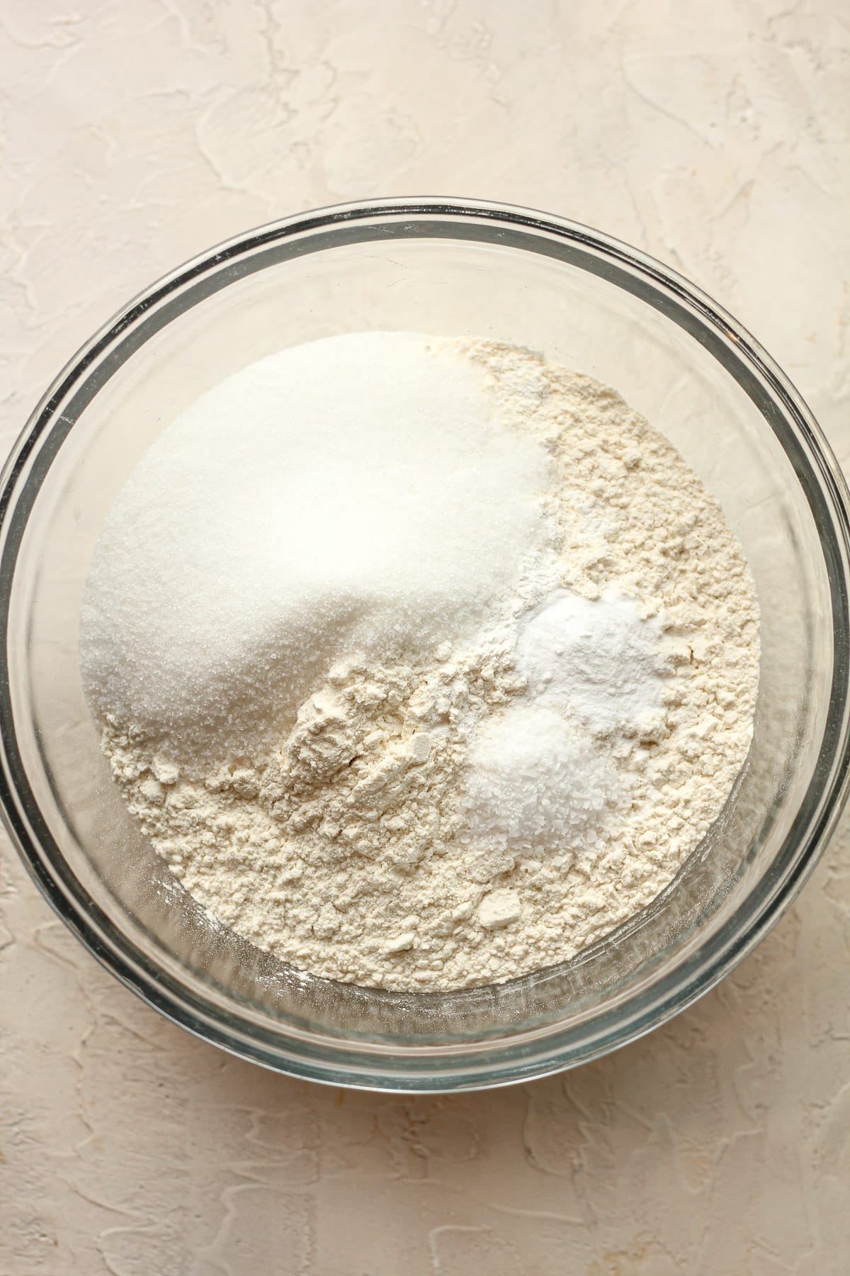 A bowl of the dry ingredients - flour, sugar, baking soda, baking powder, and salt.