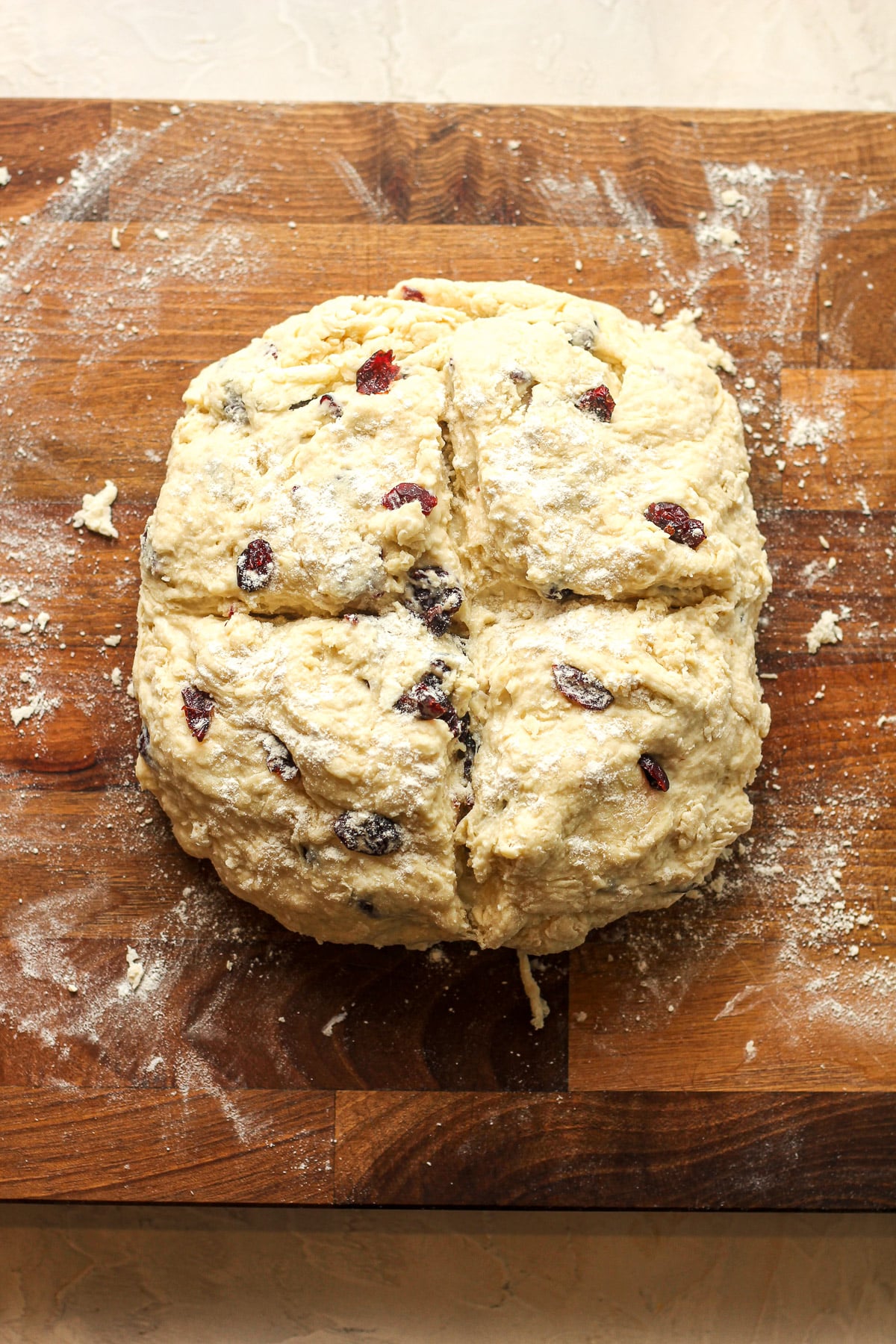 A board with an unbaked loaf of Irish soda bread.