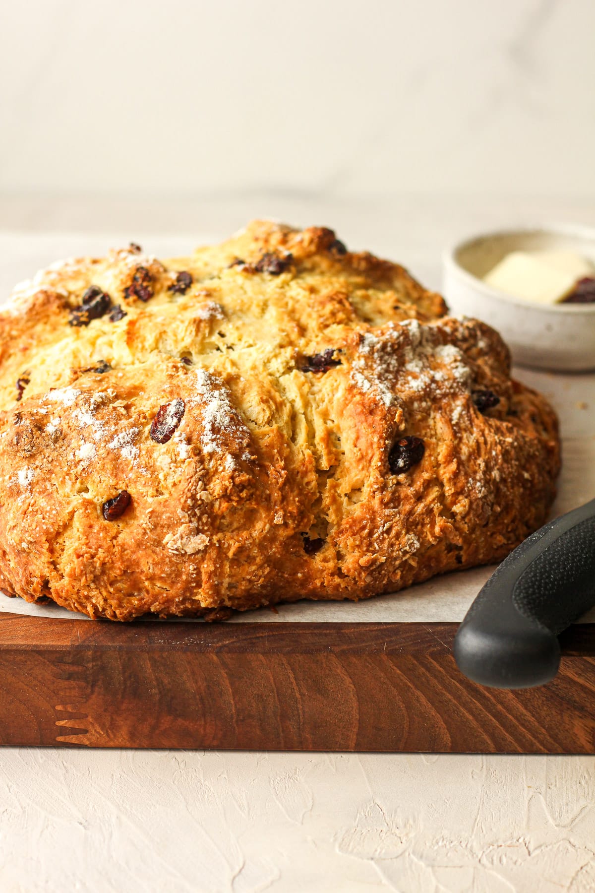 Side view of a loaf of Irish soda bread with a knife.