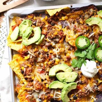 A sheet pan of beef and bean nachos.