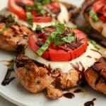 Side view of Caprese chicken with balsamic glaze.