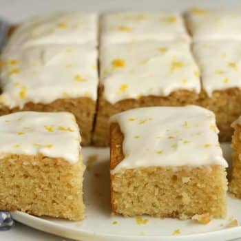 Side view of sliced lemon cake with cream cheese frosting.