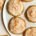 A plate of pumpkin spice cookies with frosting.