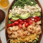 Closeup on a shrimp avocado salad with feta cheese.