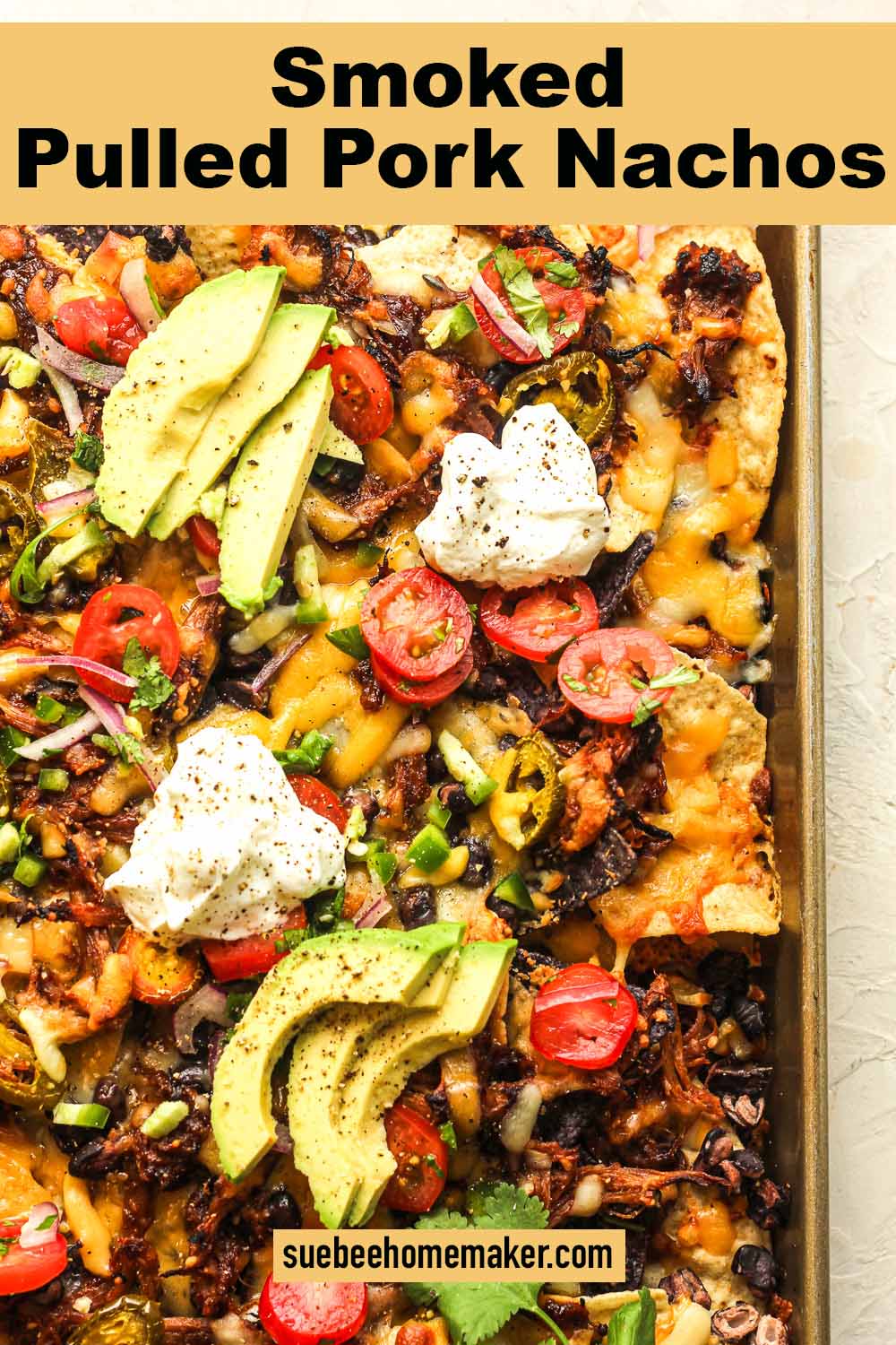 A tray of smoked pulled pork nachos with toppings.