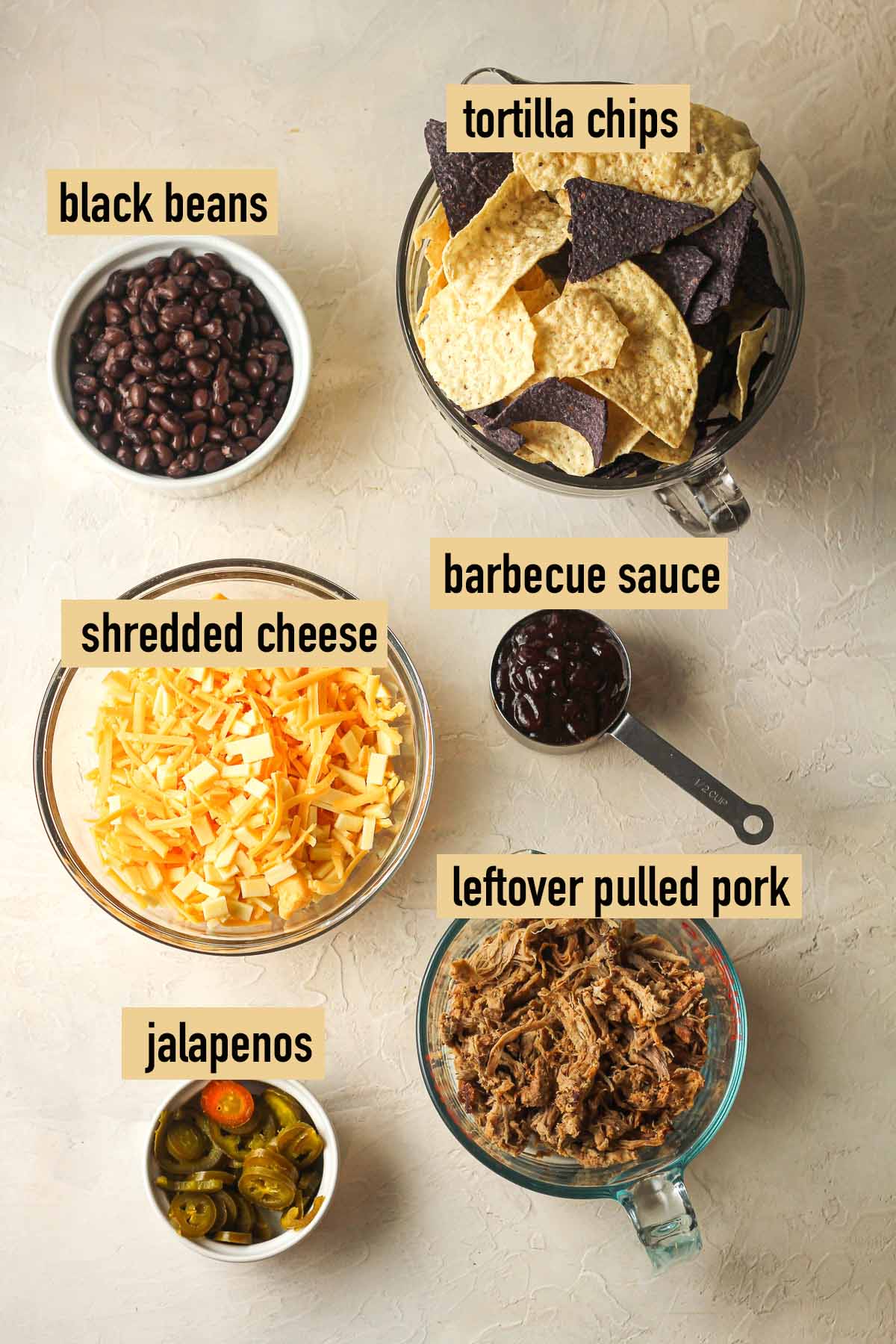 The labeled ingredients for smoked pulled pork nachos.