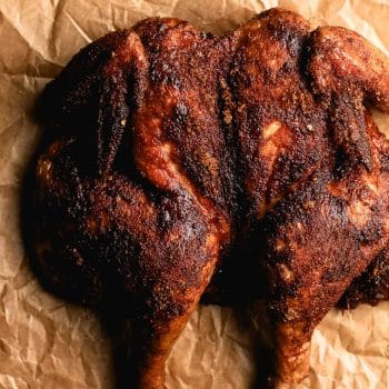 A spatchcocked chicken with blackened seasoning.