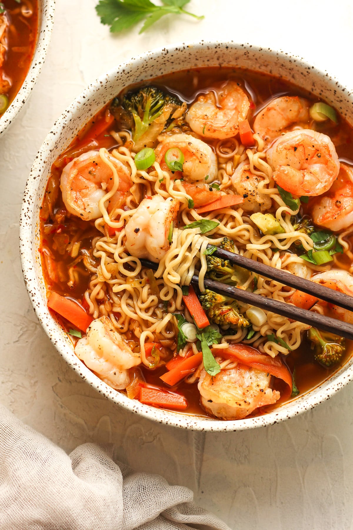 Closeup on a bowl of ramen with spicy shrimp and veggies.