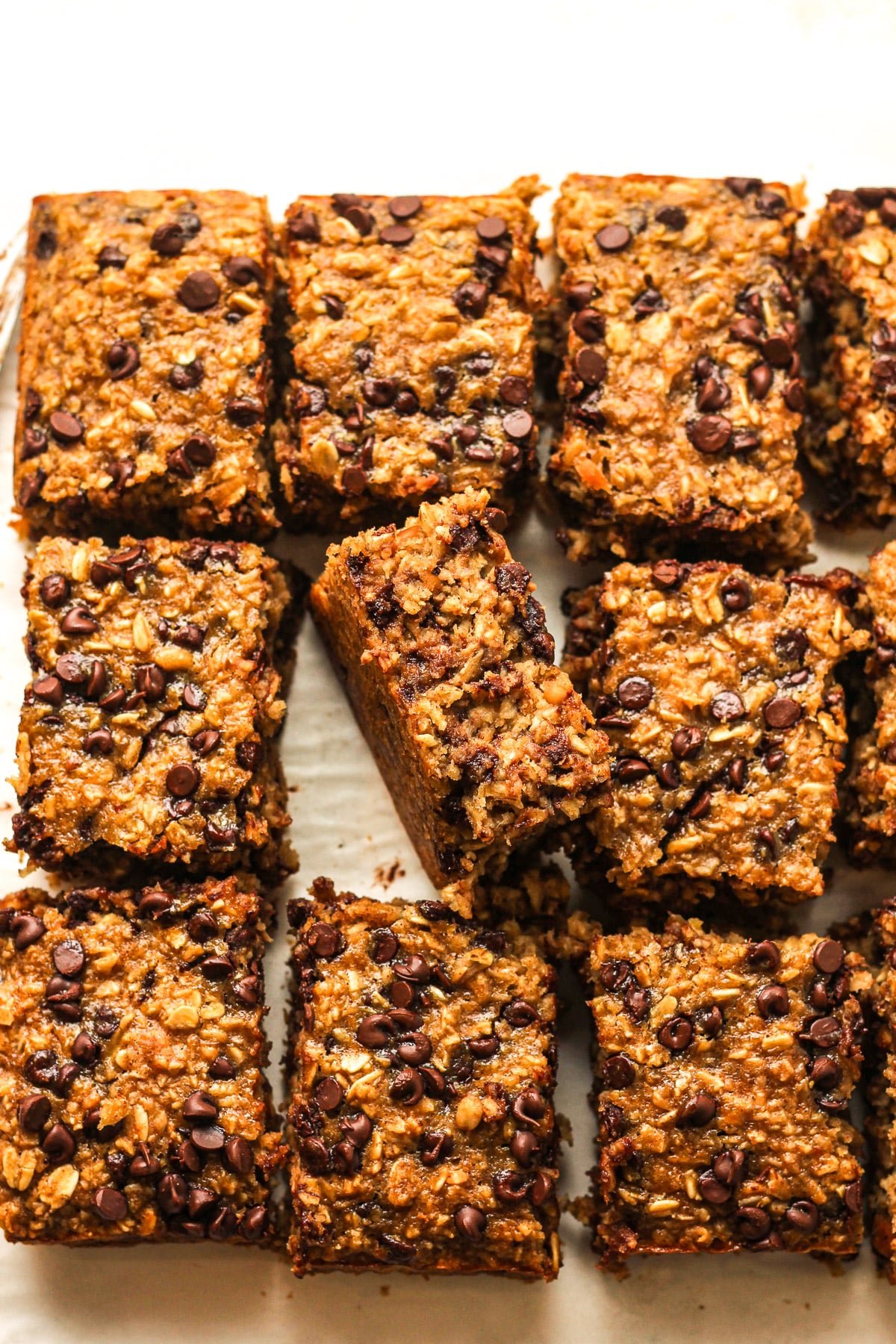 Overhead view of the sliced banana oatmeal bars with one on its side.