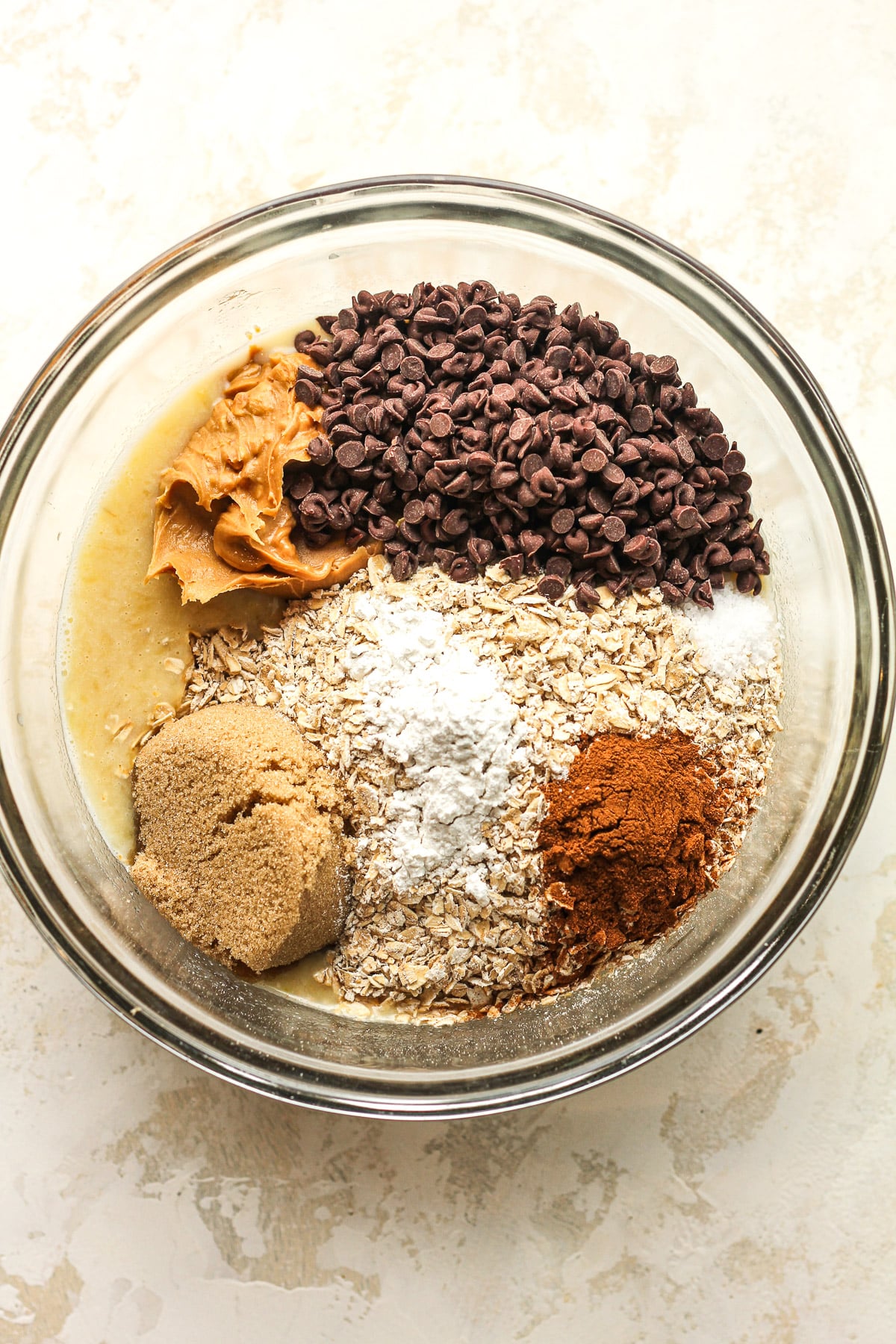 A bowl of the mixture after adding the dry ingredients on top.