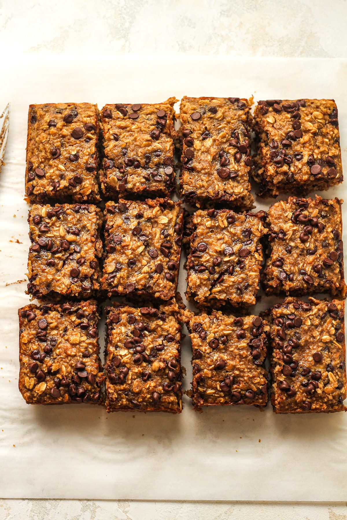 Overhead view of 12 sliced healthy oatmeal bars.