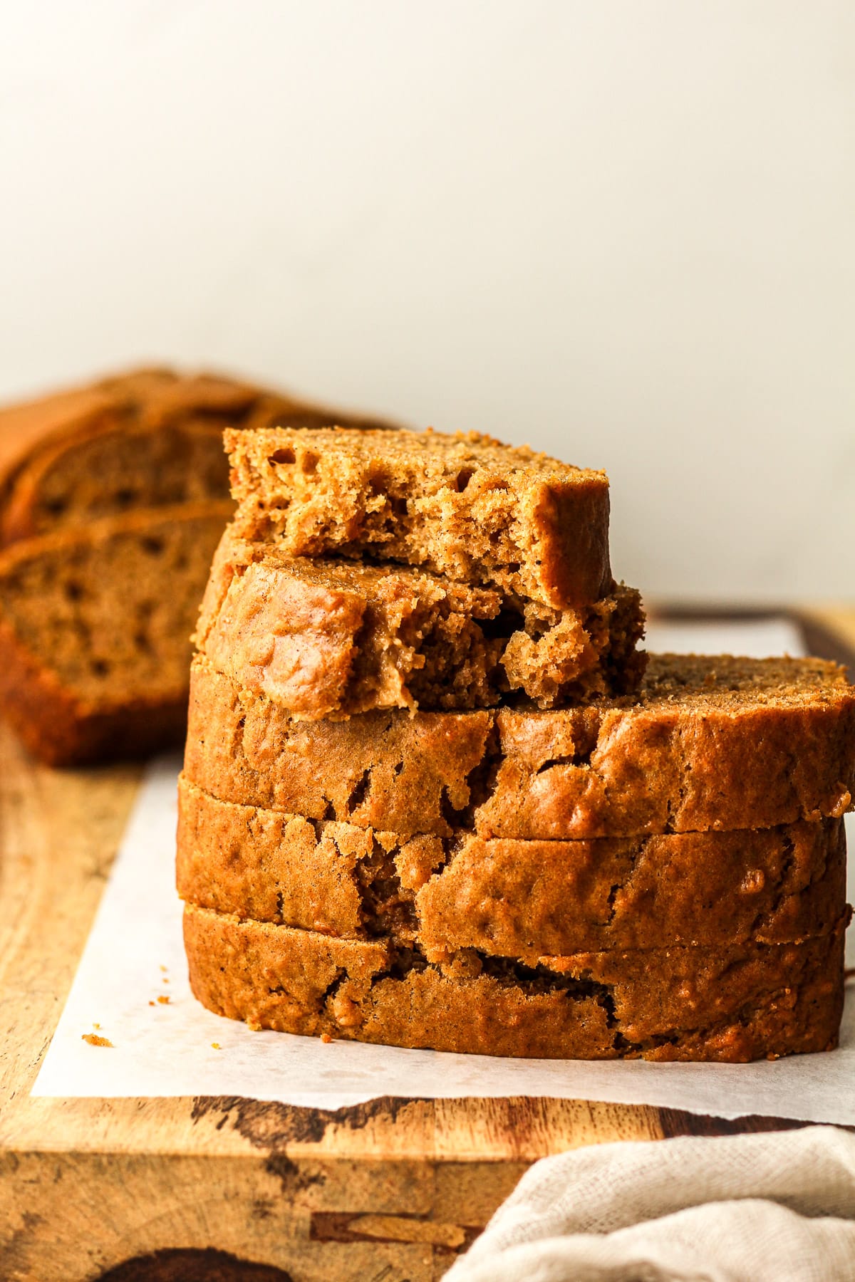 Three stacked pieces of sweet potato bread with a partial piece on top.