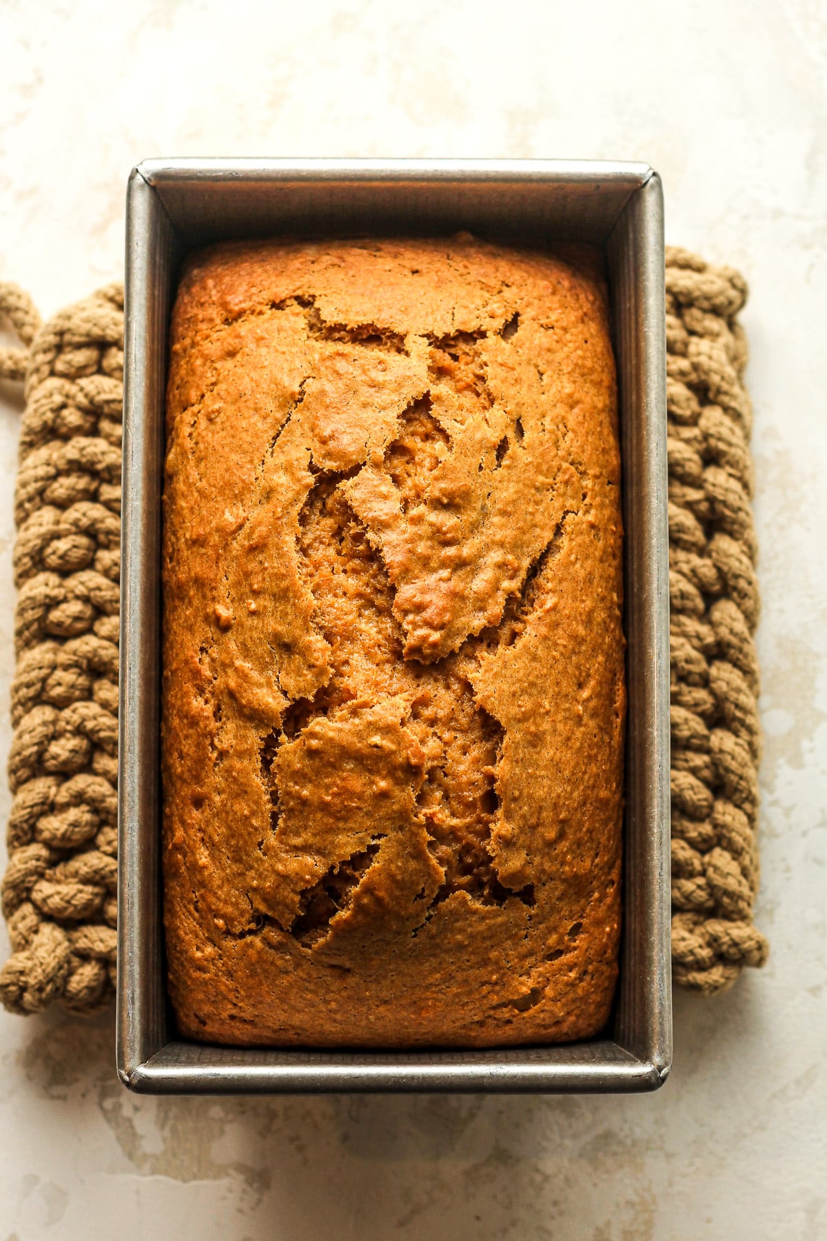 A loaf pan of baked cinnamon sweet potato bread.