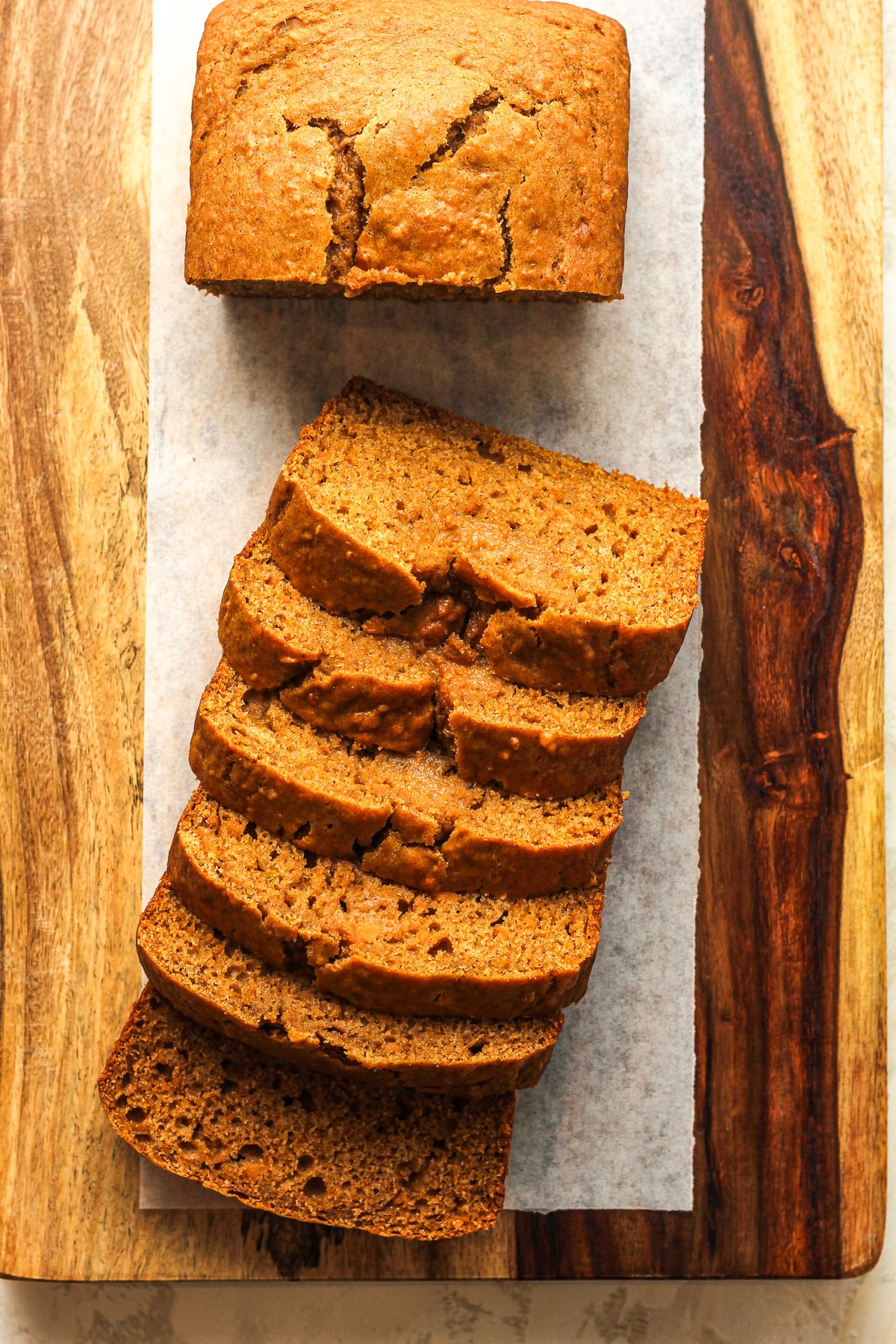 Overhead view of a loaf of sweet potato bread with some of them sliced.