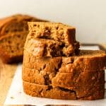 Three pieces of stacked sweet potato bread with a partial piece on top.
