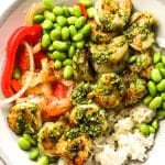 Closeup on shrimp pesto rice bowl with edamame.