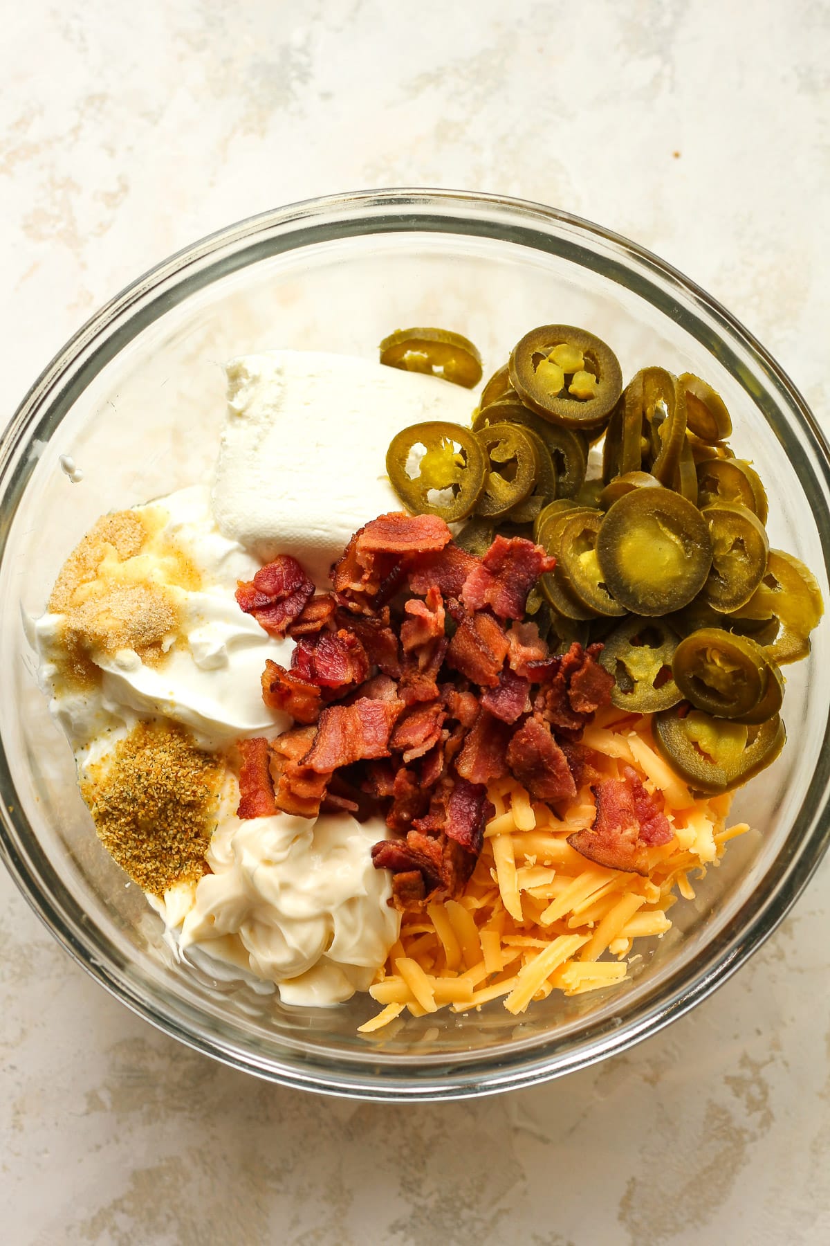 A bowl of the jalapeño popper dip ingredients before combining.