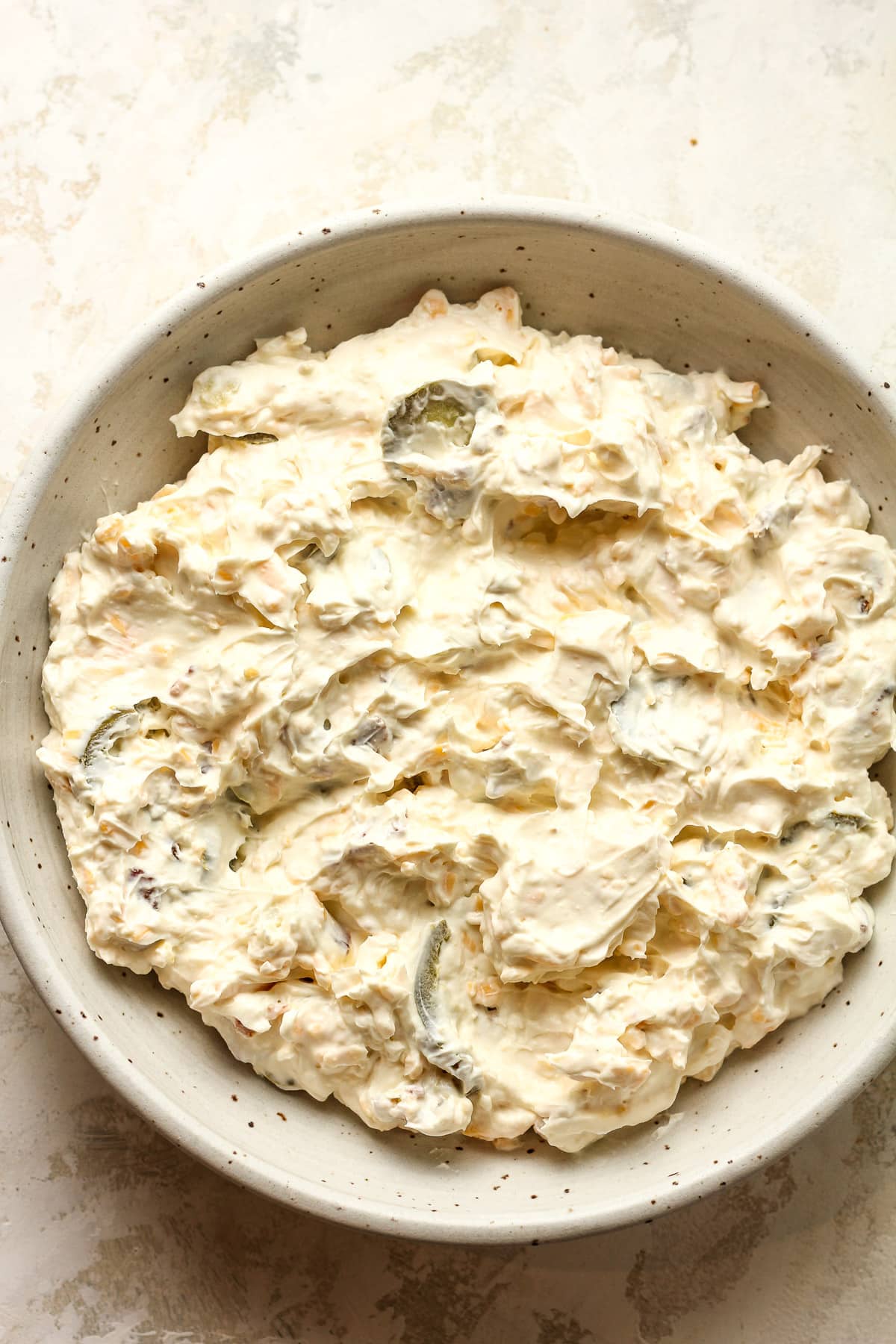 The creamy dip spread in a serving bowl before baking.