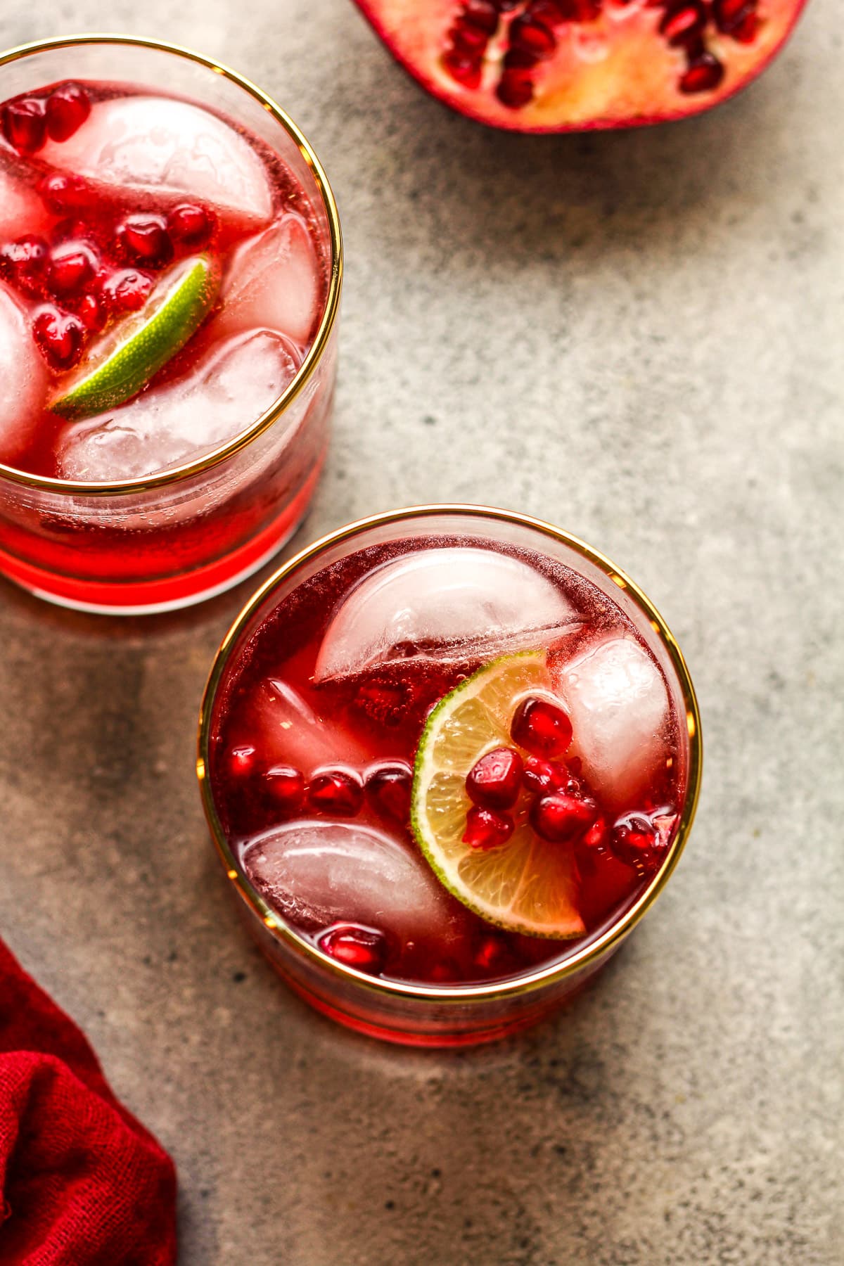 Overhead view of two glasses of pomegranate mules with pomegranate arials.