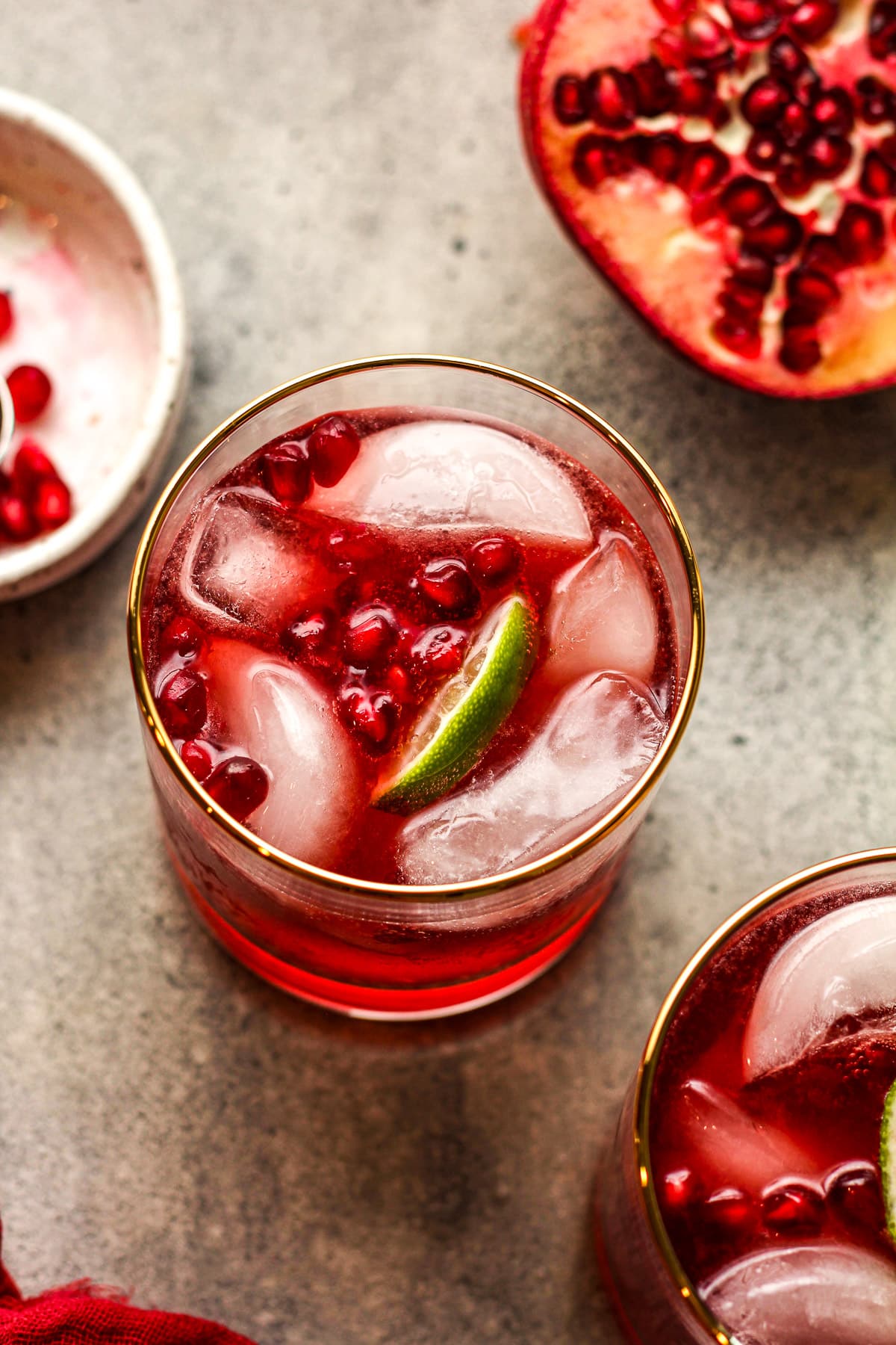 Overhead view of two Moscow mules with pomegranate and fresh limes.