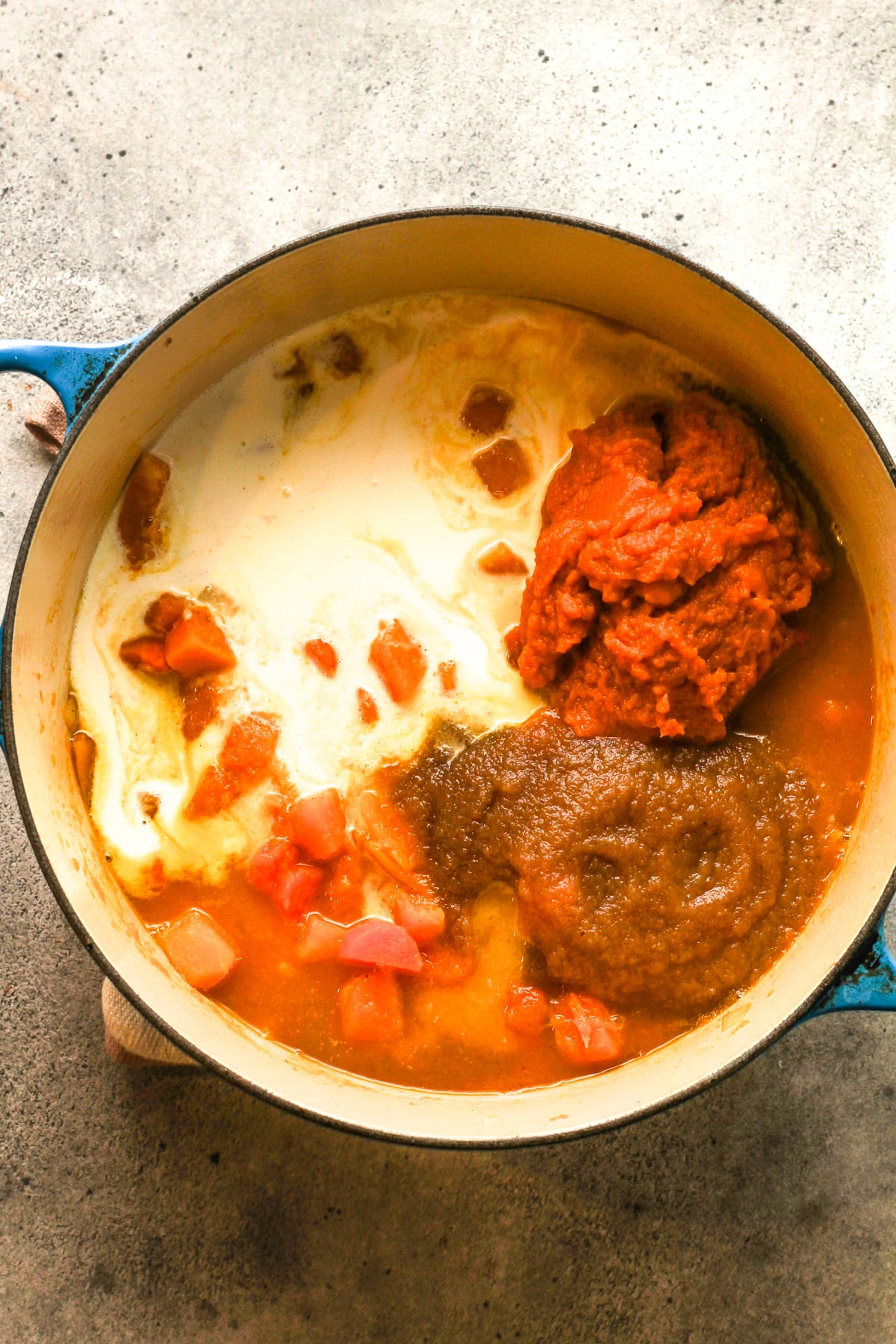 The pot of the cooked mixture with the pumpkin, cinnamon applesauce, and cream added in.