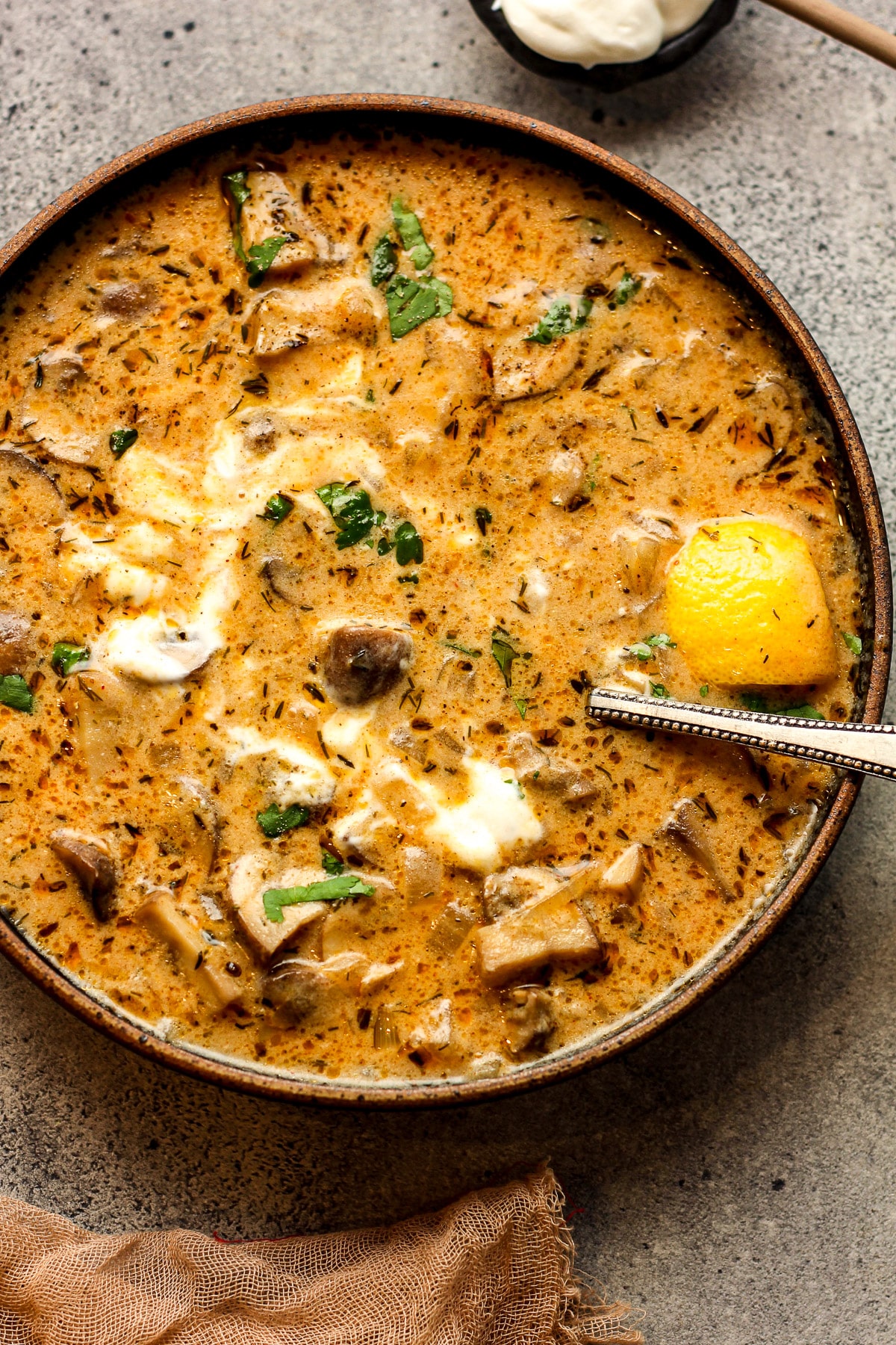 A bowl of Hungarian mushroom soup with sour cream.