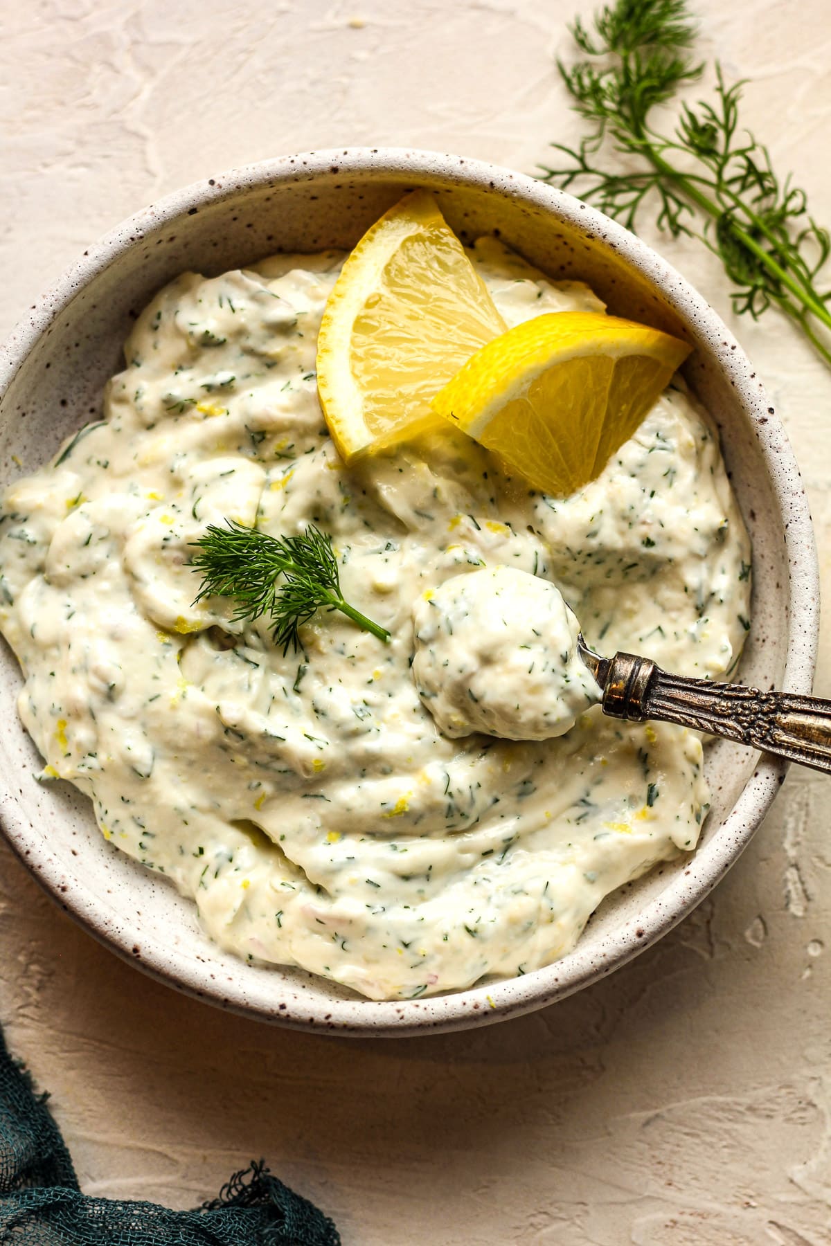 Overhead view of the lemon dill sauce with a spoonful on top.