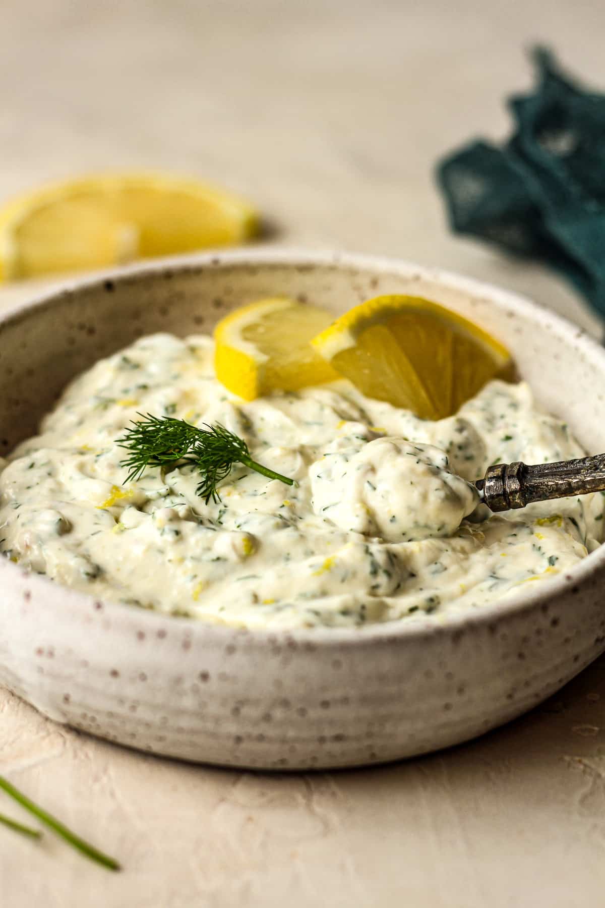 Side view of a bowl of the sauce with a spoonful on top.