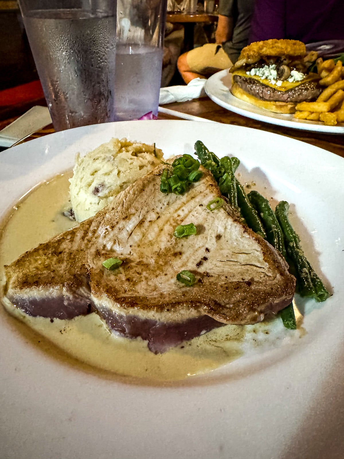 A plate of seared mahi mahi and sides.