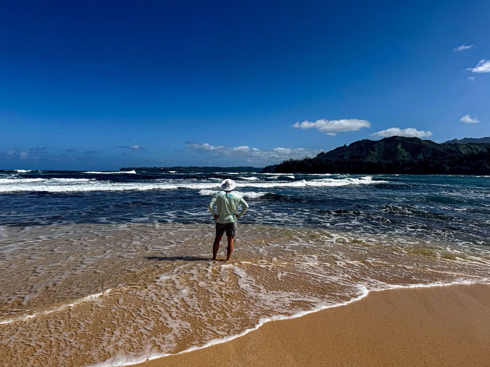 Mike standing in in the shallow part of the ocean on Kauai's north shore.