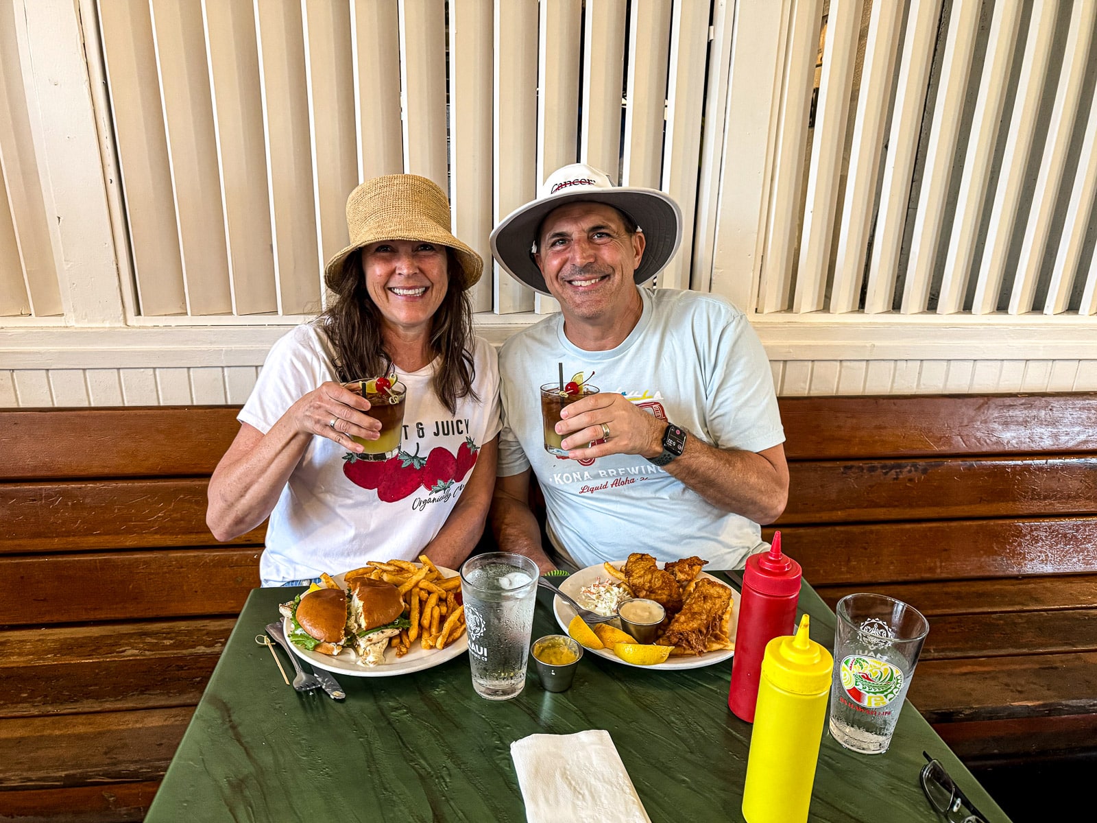 Mike and I eating at The Hanalei Gourmet with Mai Tai drinks in hand.