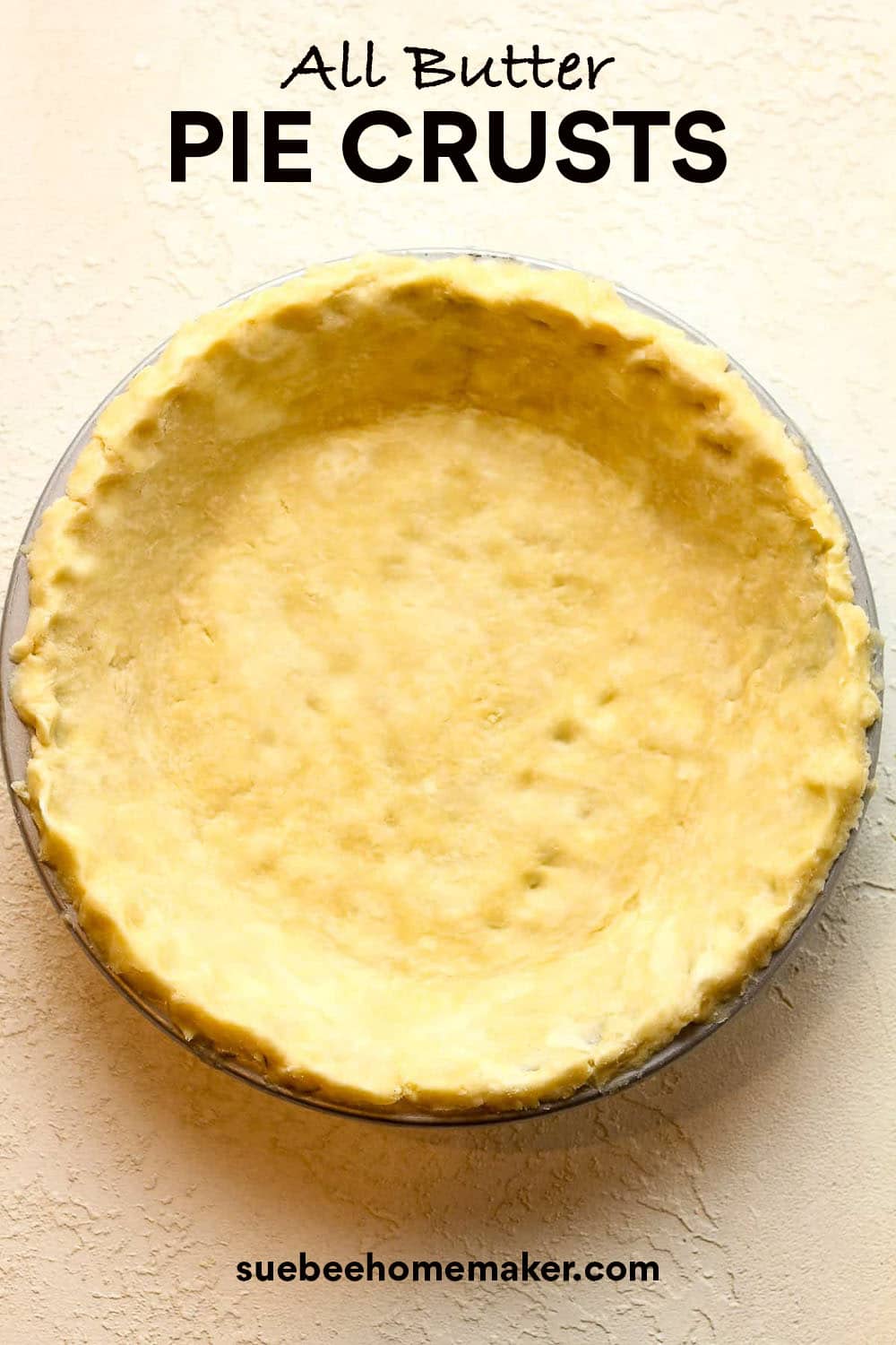 An all butter pie crust pressed into a glass pie dish.