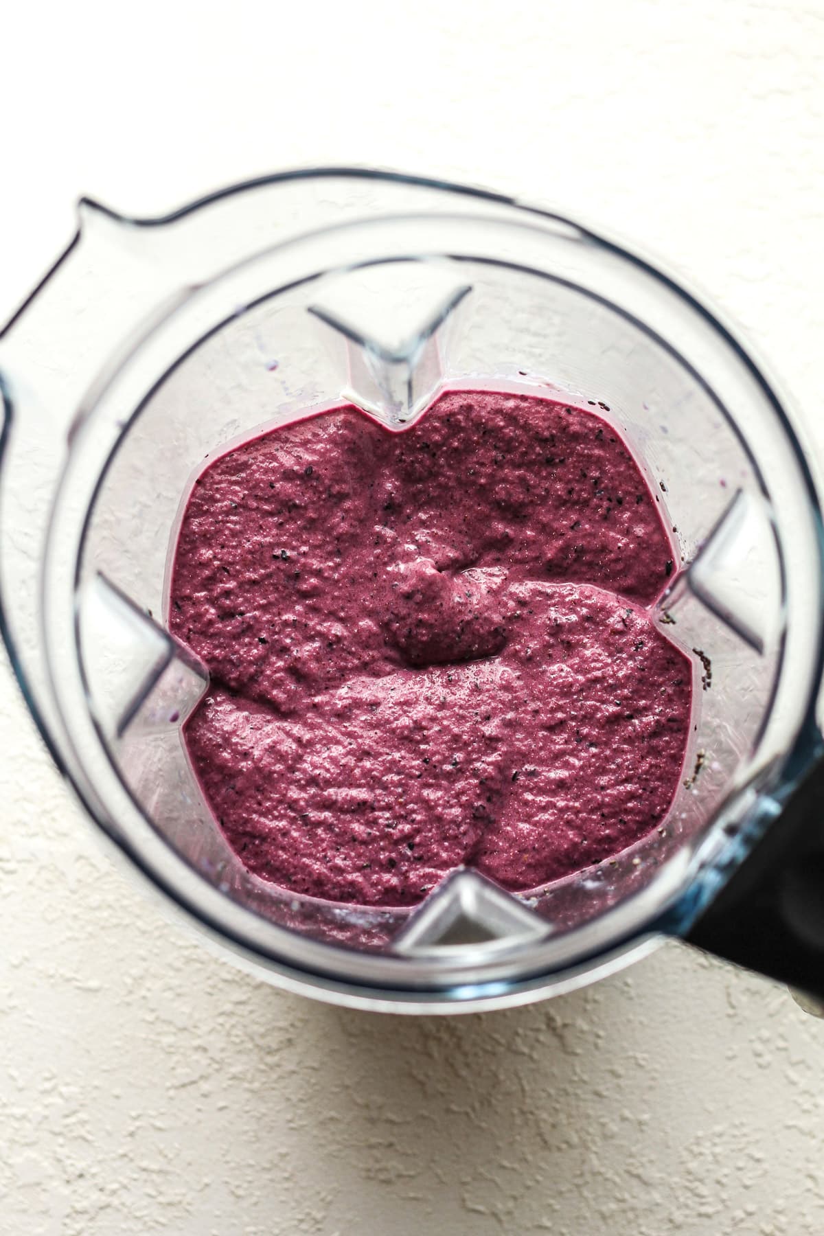 Overhead view of a blender of the blueberry smoothie mixture.
