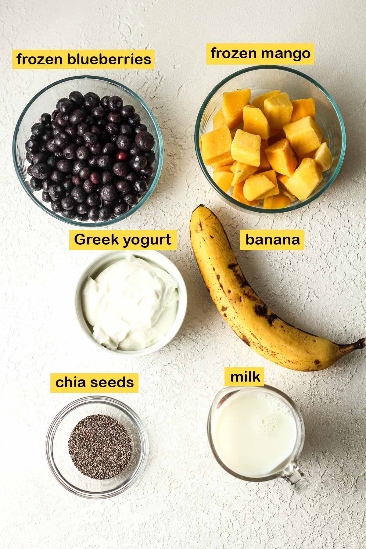 Labeled ingredients for the blueberry mango chia smoothies.