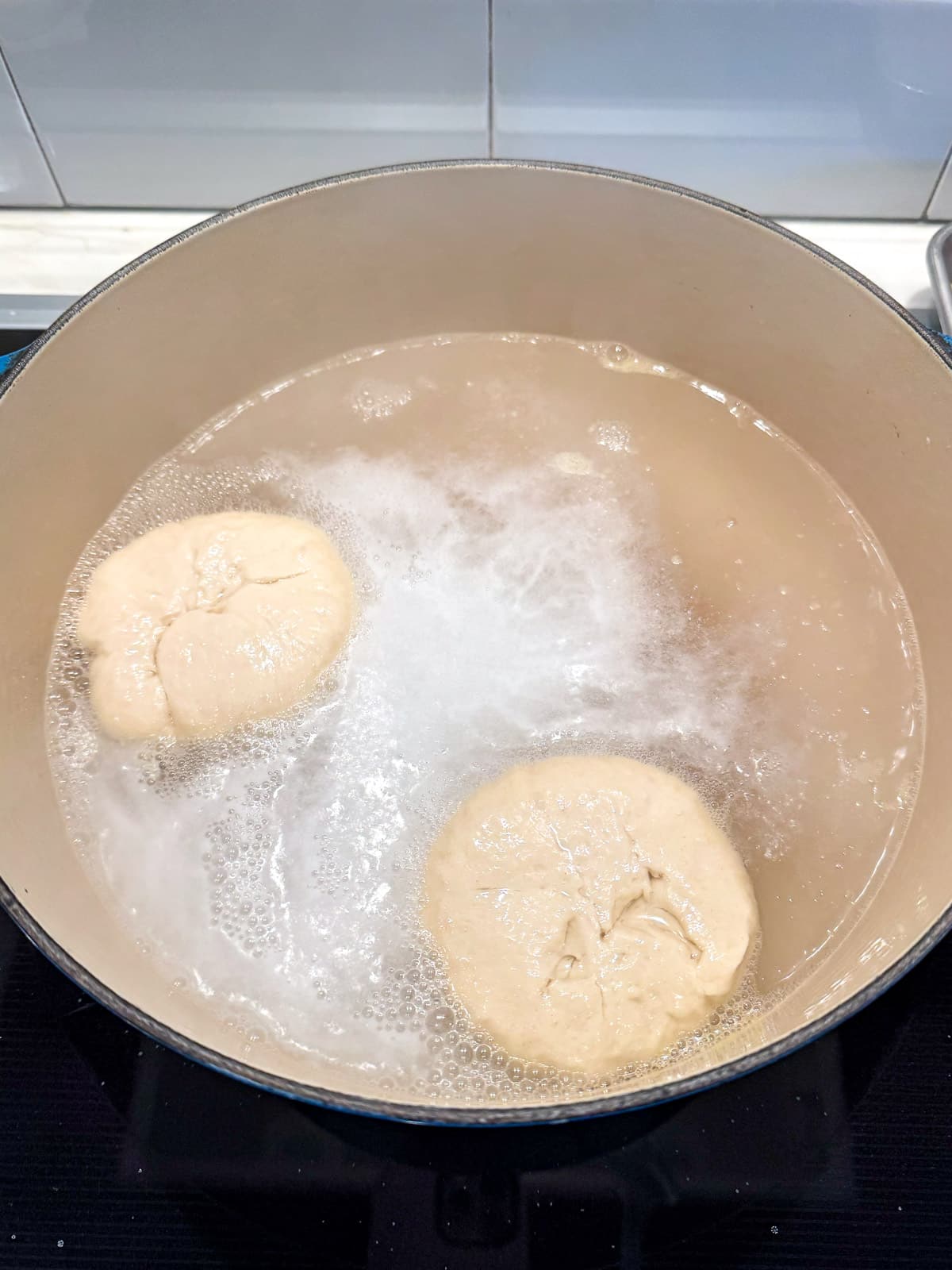 The pot with two pretzel buns boiling.
