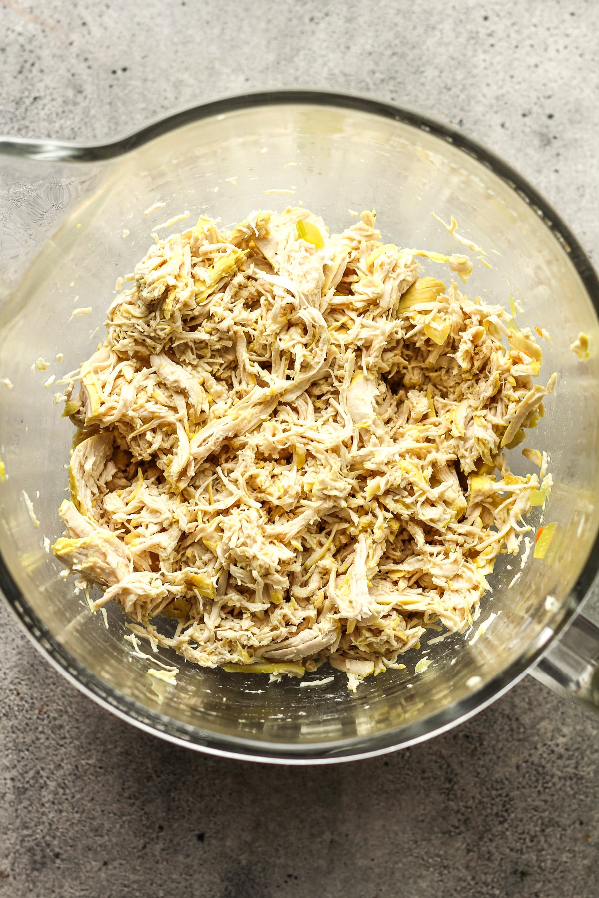 A mixing bowl of the shredded chicken.